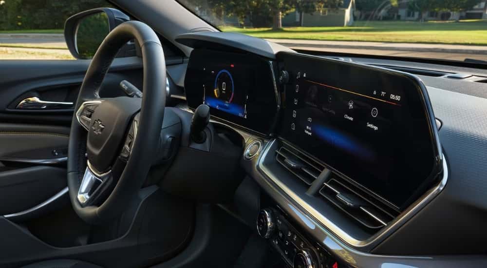 Interior view of a 2026 Chevy Trax steering wheel and infotainment system.