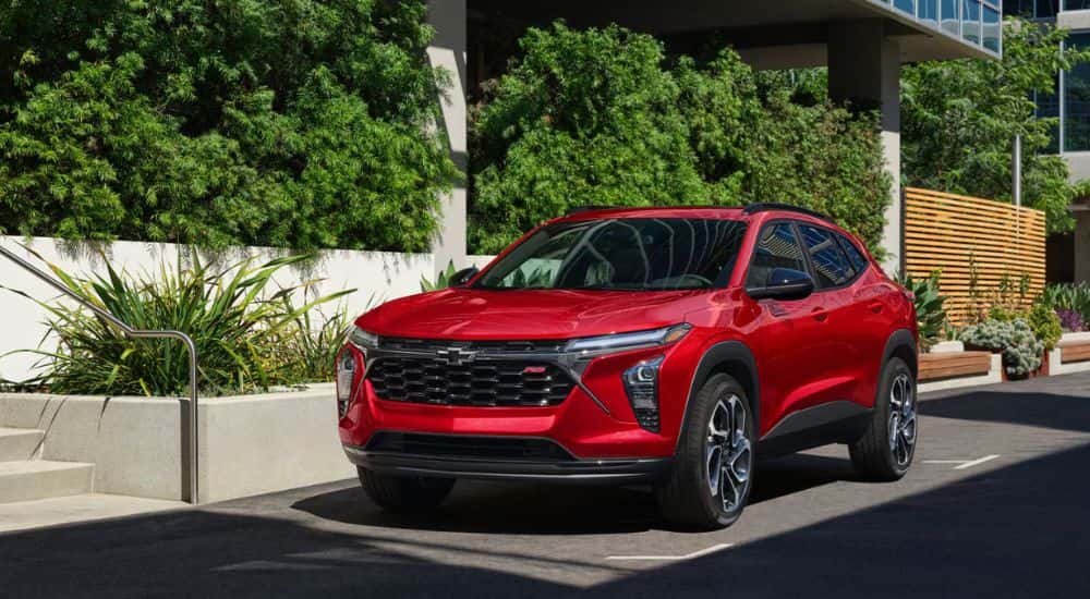 A red 2026 Chevy Trax parked next to a building.