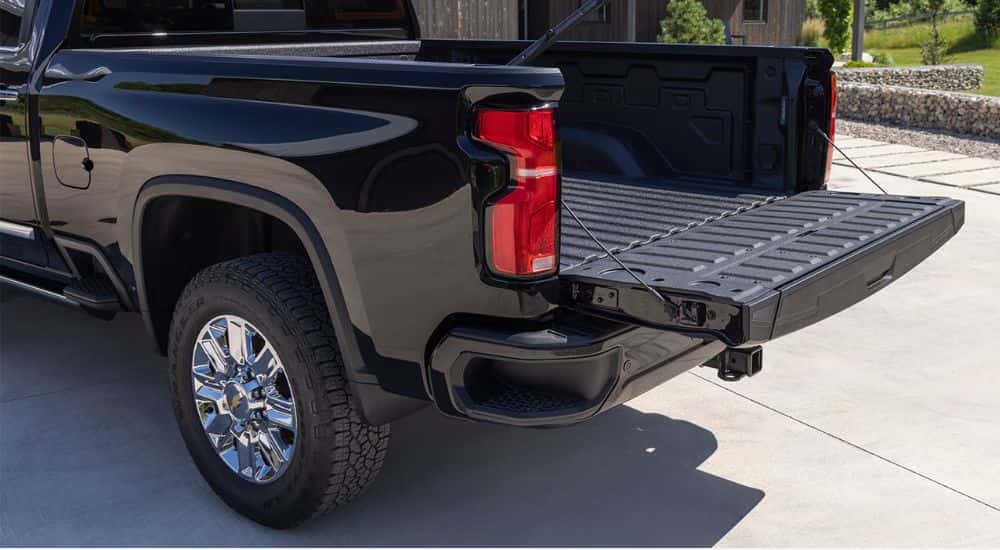Rear gate down on the bed of a black 2026 Silverado 2500 HD.