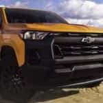 A yellow 2026 Chevy Colorado parked near water.