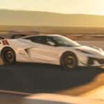 White 2027 Chevy Corvette Grand Sport speeding on a racetrack.