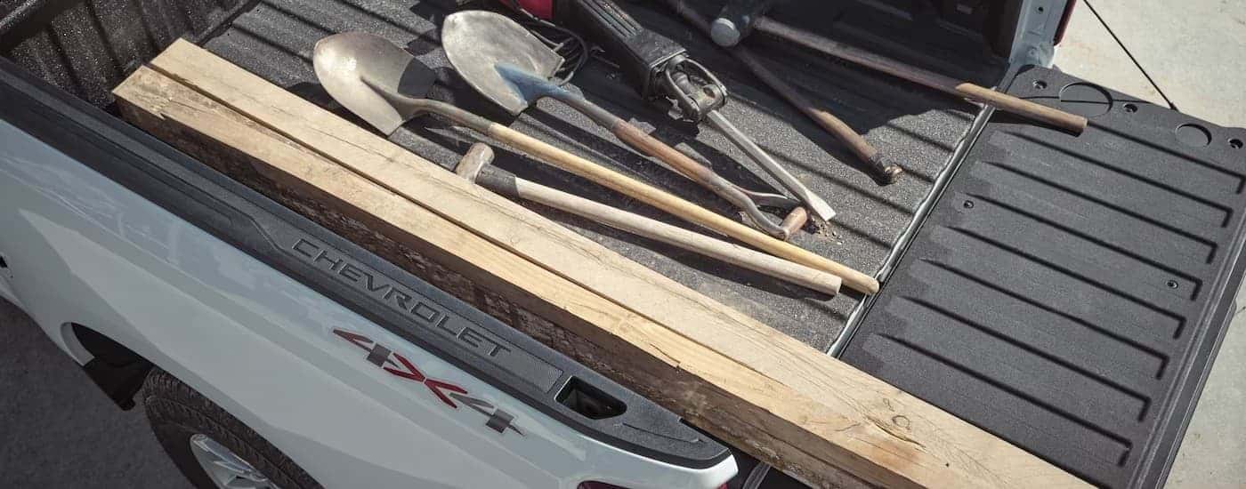 Tools in the bed of a white2026 Chevy Silverado 1500.