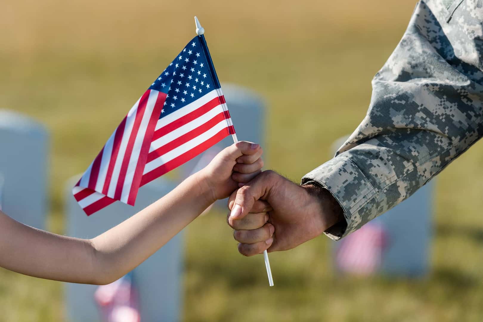man and child holding american flag
