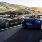 Two 2025 Porsche 718 Boxster models driving opposite directions on the highway