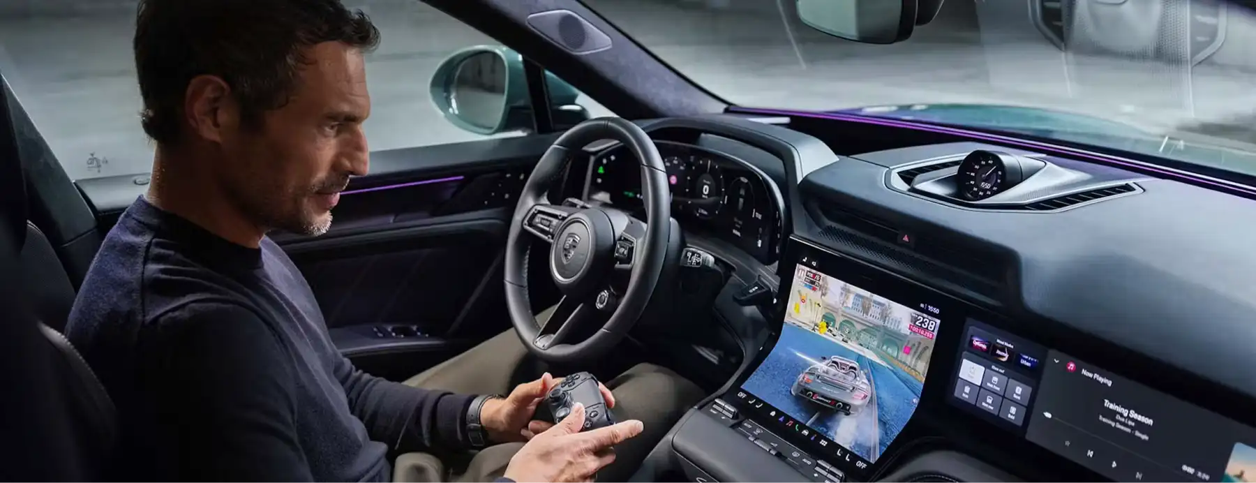 Man_playing_games_inside_car_on_Porsche_Cayenne_Electric_large_central_display