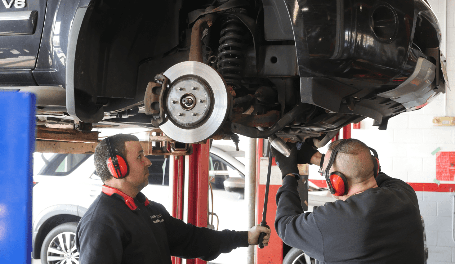 Mechanics working on vehicle