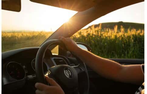 Driver at the wheel during a golden-hour country drive