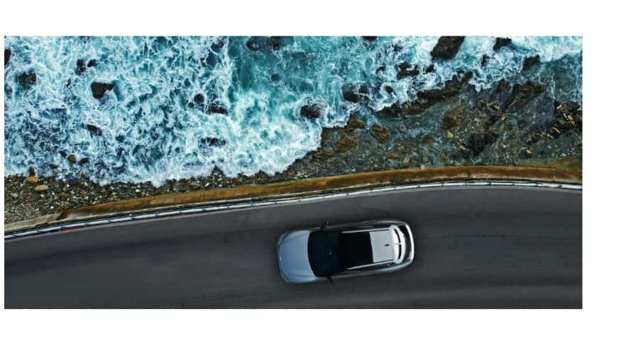Aerial view of a car on a coastal road