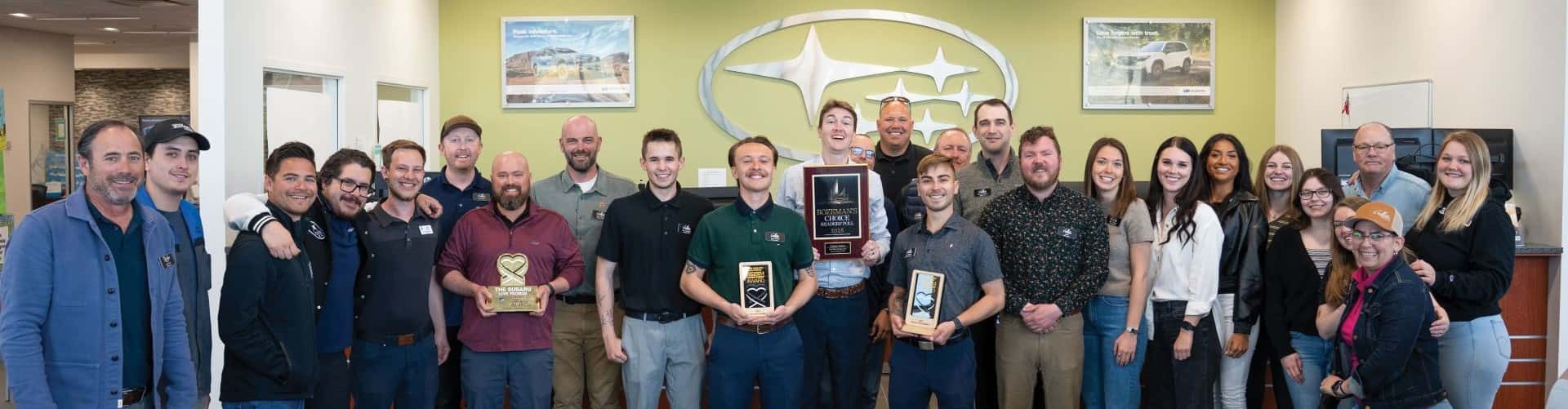 This photo showcases the Gallatin Subaru Sales and Service team with their recently won awards, positioning them as one of the Gallatin County's top auto dealerships.