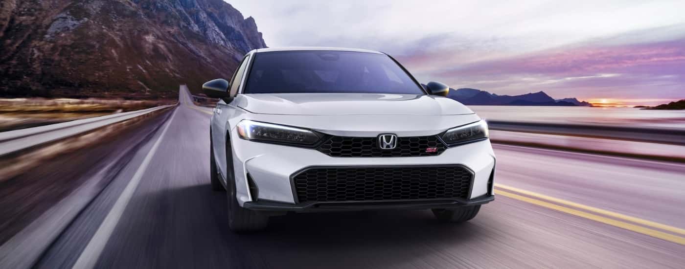White 2026 Honda Civic Si driving to a Honda dealer