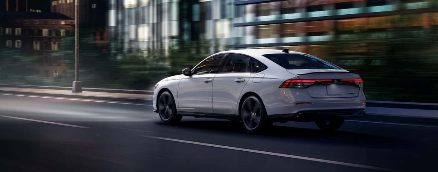 A white 2026 Honda Accord from the rear after leaving a Honda dealer near Foxleigh.