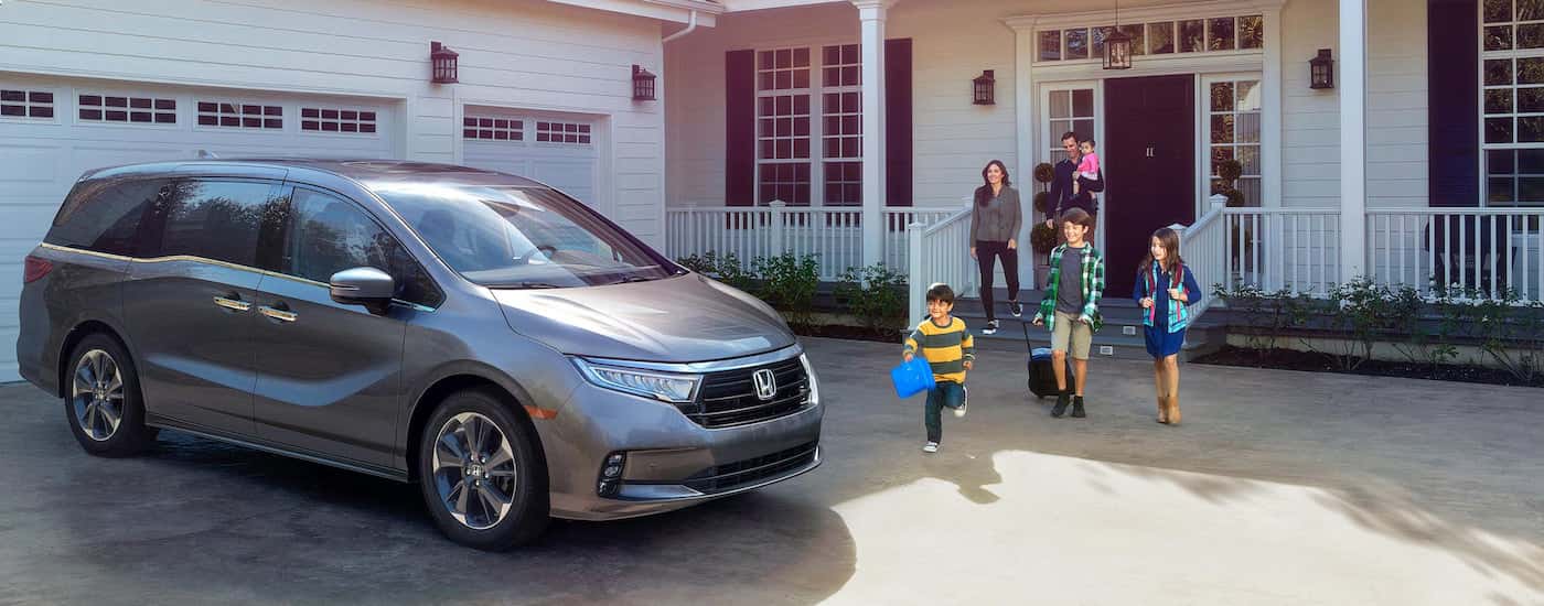 Silver 2026 Honda Odyssey parked on a driveway.