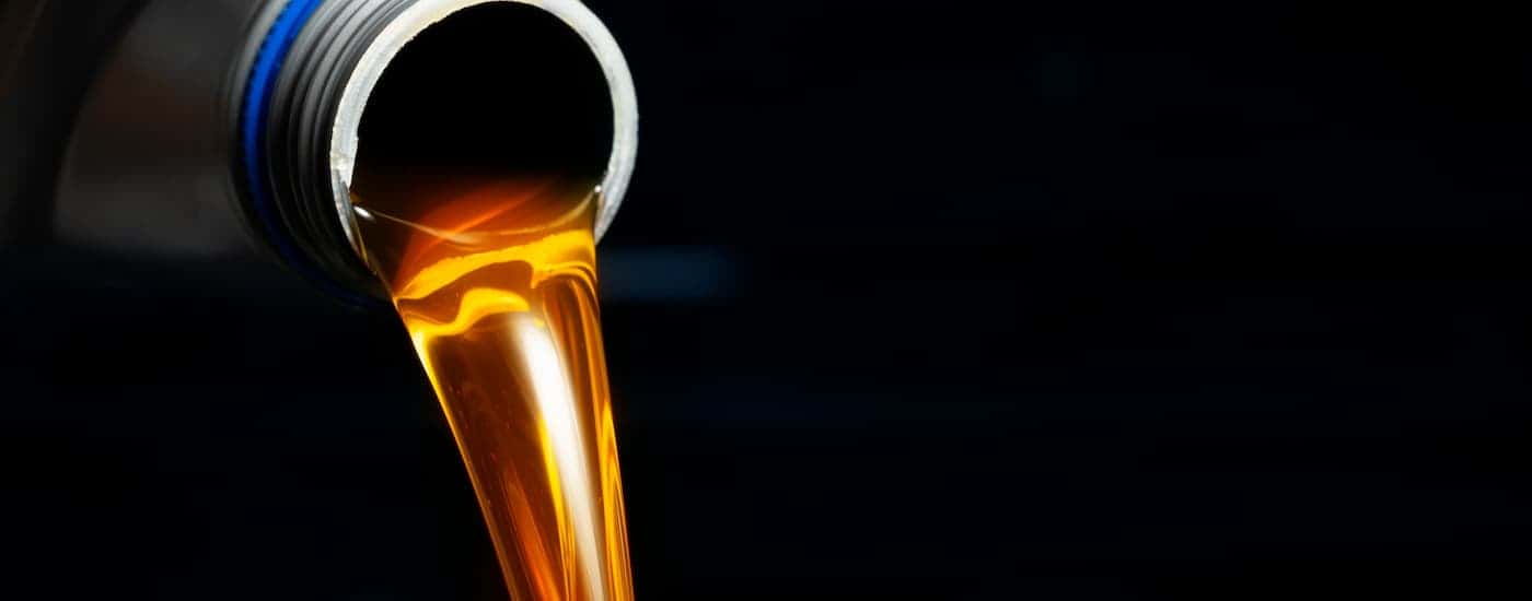 Oil pouring out of a gre y bottle