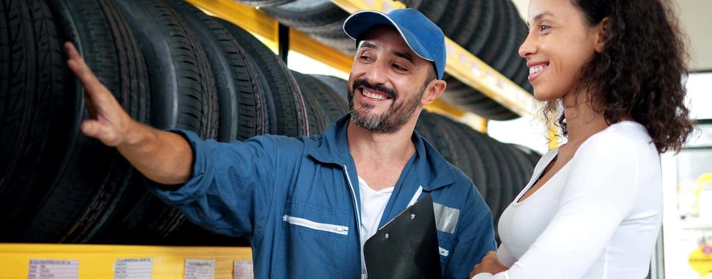 Customer and mechanic discussing tires