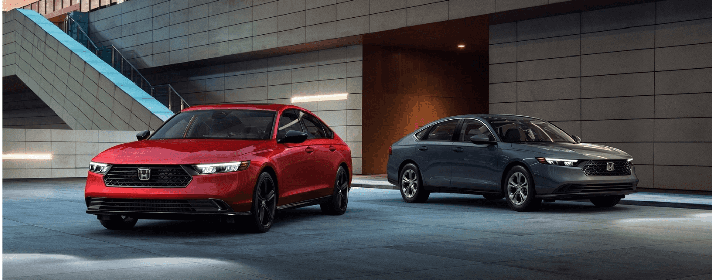 Red and gray 2026 Honda Accords parked side-by-side.