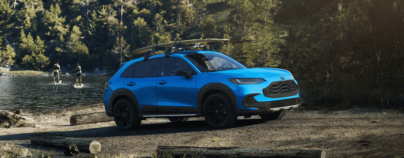 Blue 2027 Honda HR-V parked next to a lake