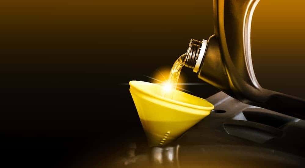 Oil being poured into a funnel.