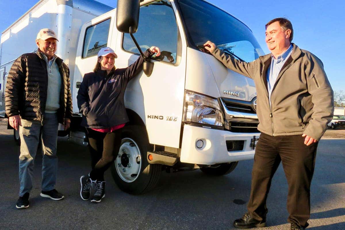 people standing with commercial truck