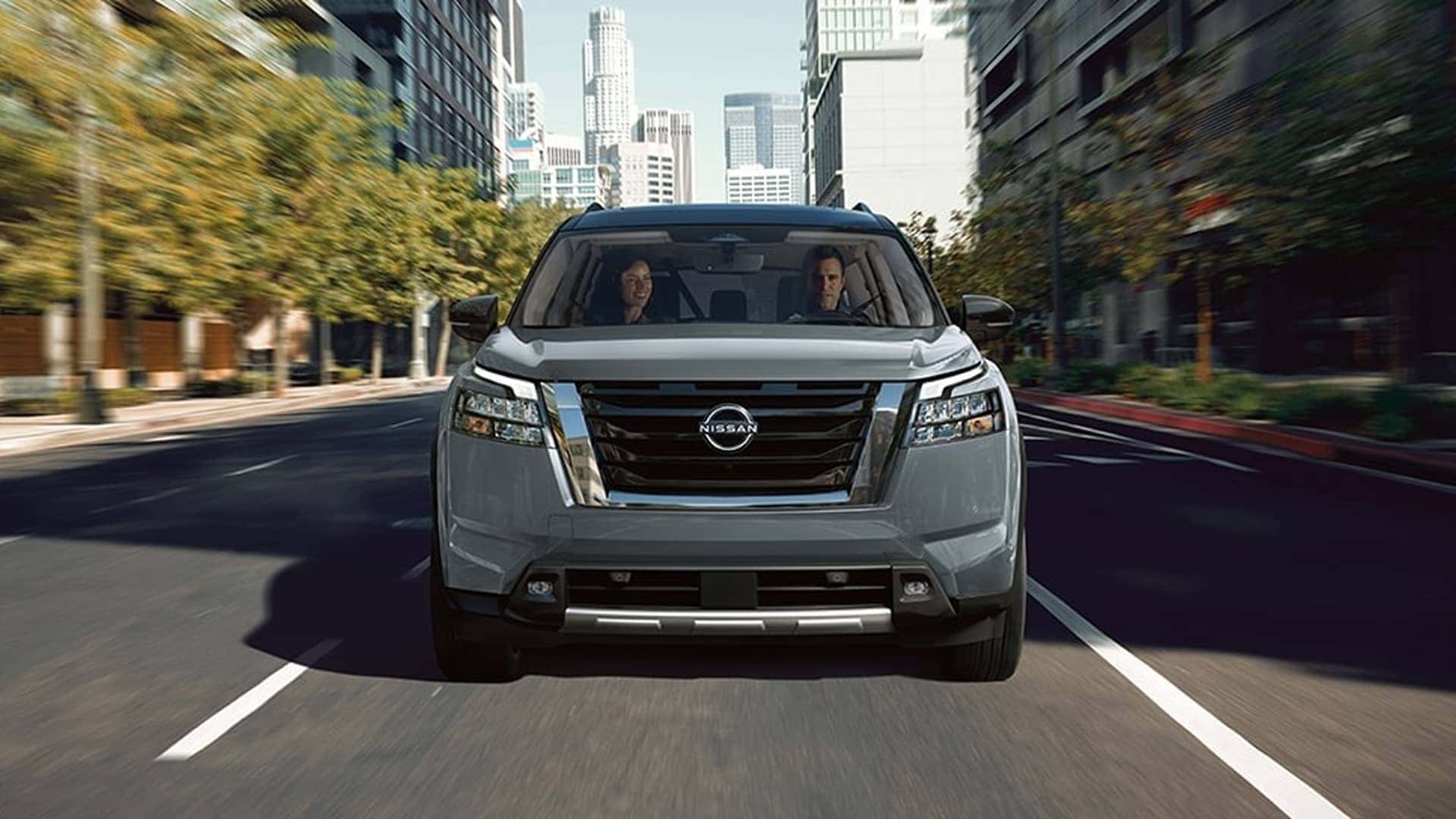 couple driving nissan pathfinder