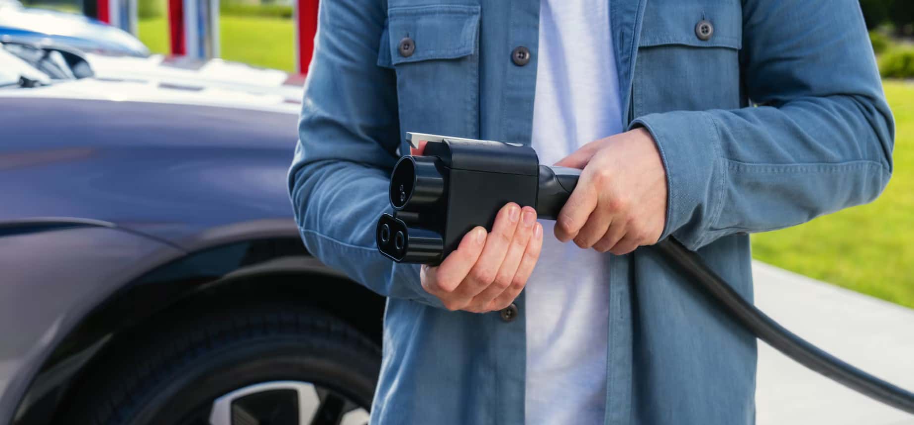 customer holding a charging cable