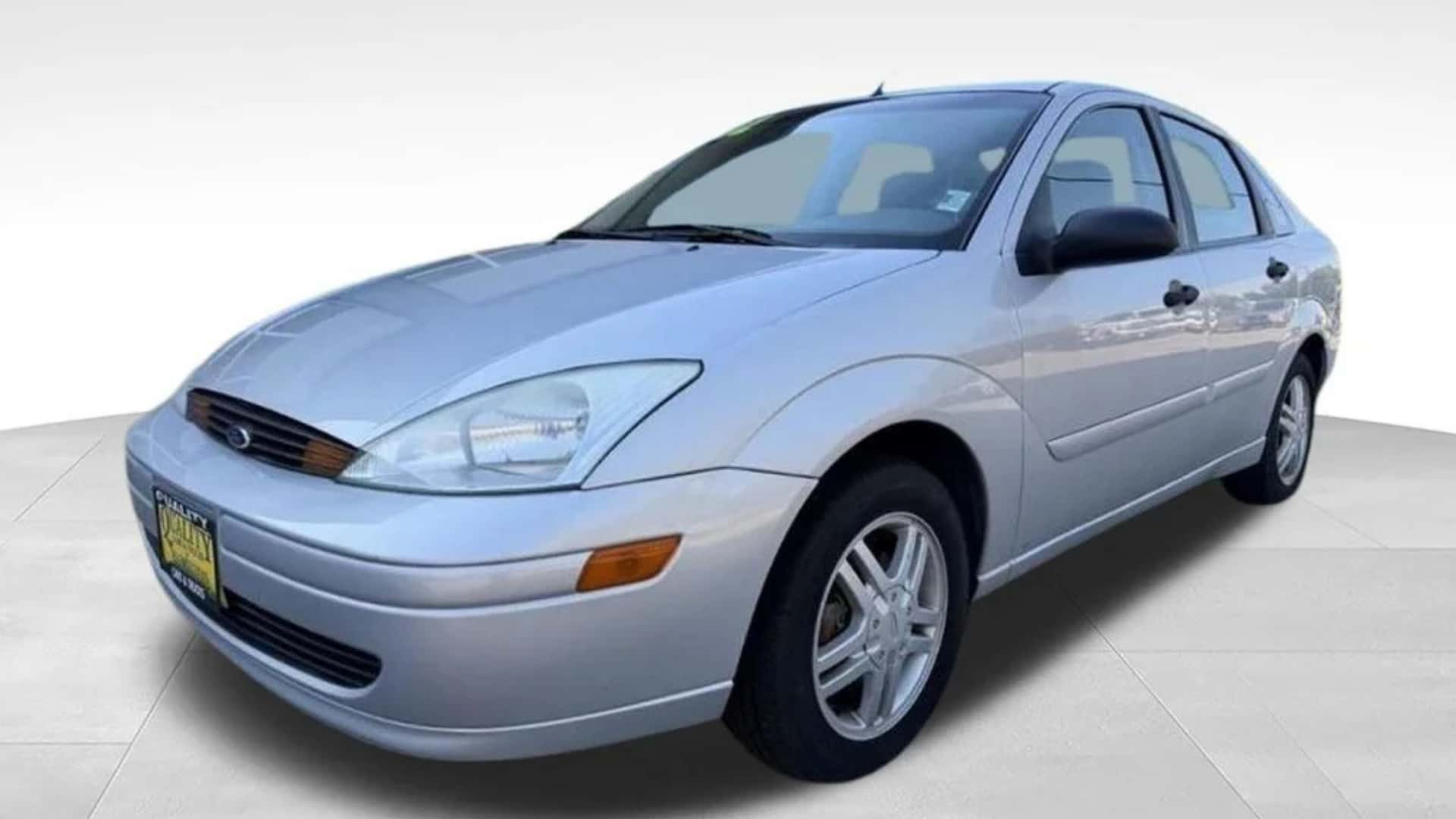 Silver Ford Focus sedan front three-quarter view with compact body styling, alloy wheels, and clean studio background.
