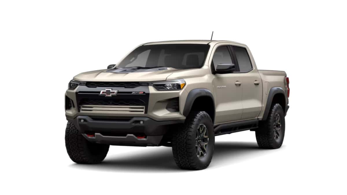 2026 Chevrolet Colorado ZR2 in tan shown in a front three-quarter studio view with rugged tires and off-road styling.