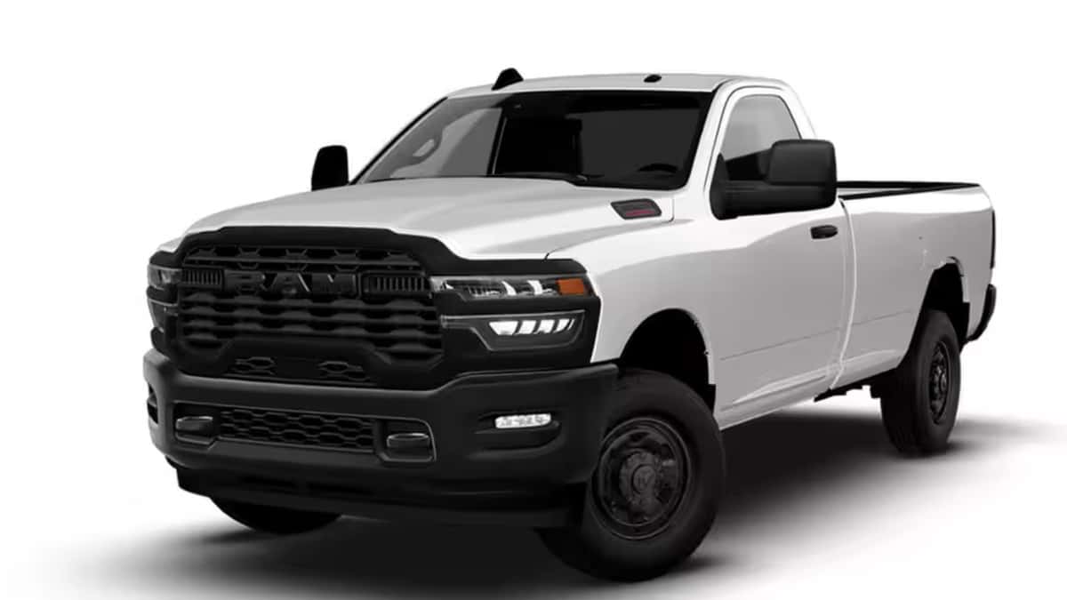 2026 Ram Heavy Duty white regular cab truck shown in a studio front three-quarter view with black grille and long bed.