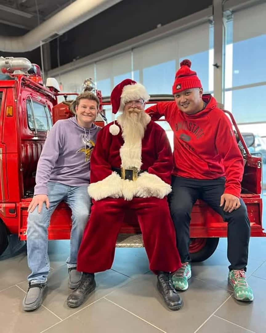 santa posing with two people