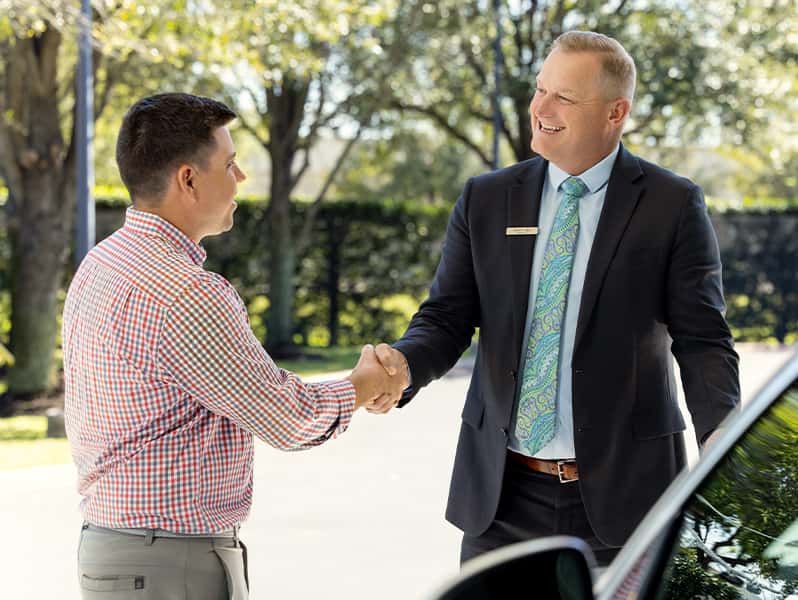 Sewell associate helping a customer with a vehicle.