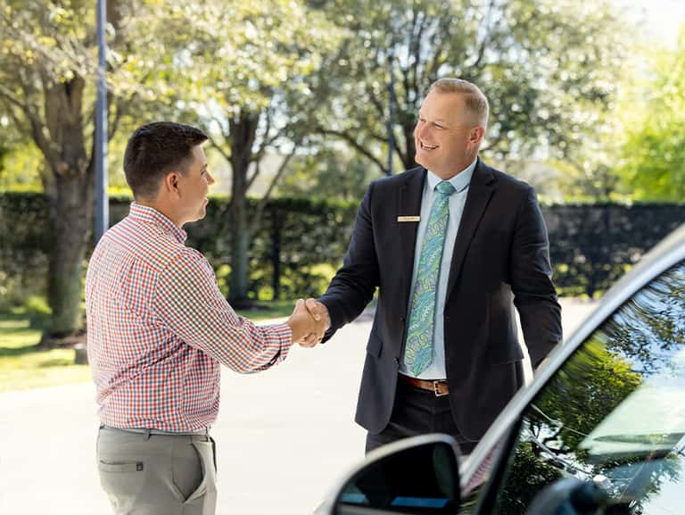Sewell associate helping a customer with a vehicle.