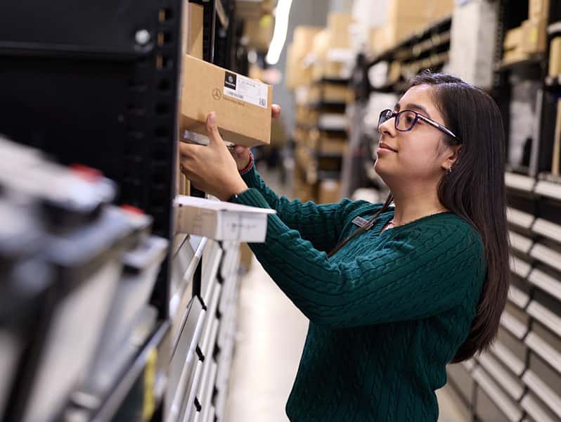 Sewell associate checking for a part in parts department.