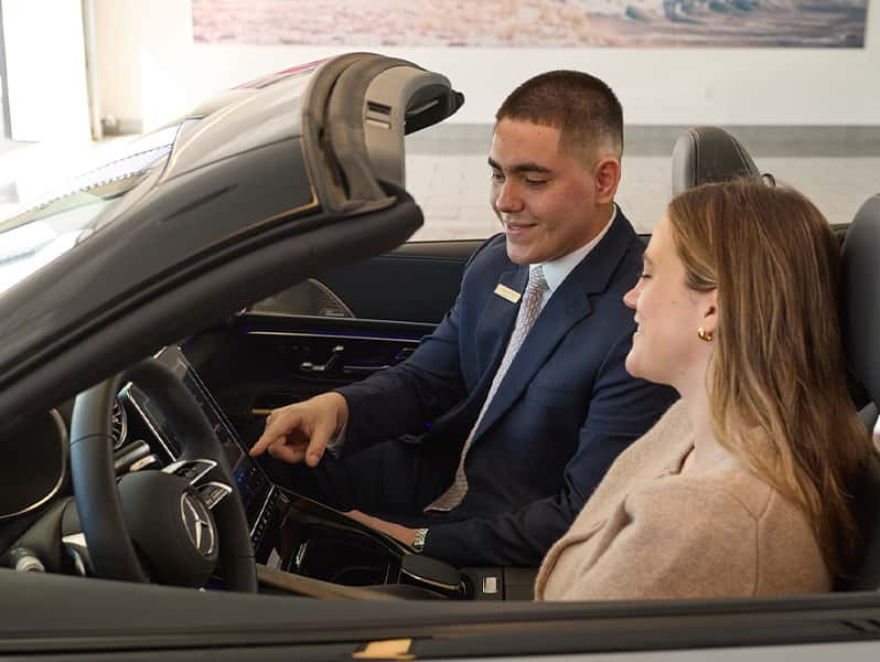 Sewell product specialist explaining vehicle features to a customer.