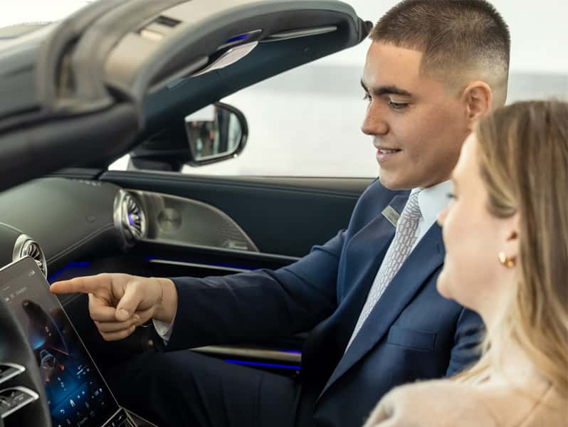Sewell Associate overviewing vehicle technology with a customer.