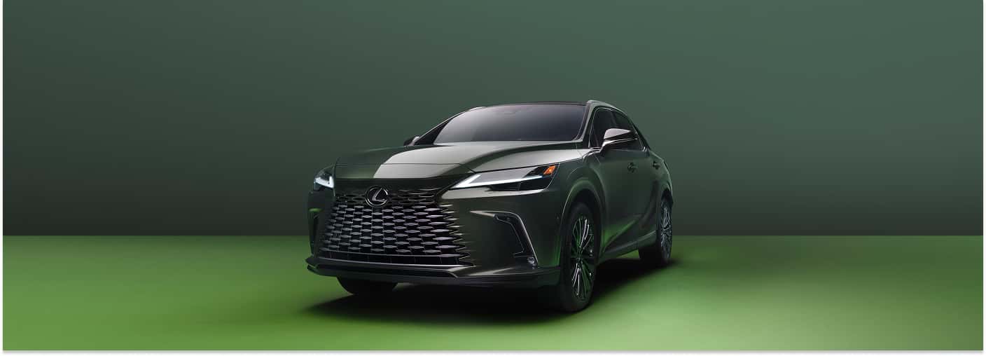 Front three-quarter view of a green 2026 Lexus RX SUV in a studio setting.