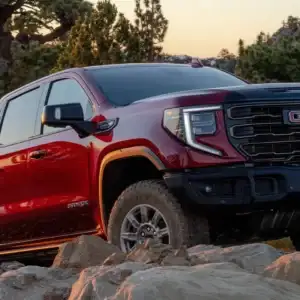 2026 GMC Sierra 1500 Volcanic Red Tintcoat rock climbing