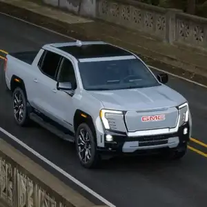 2026 GMC Sierra EV Driving Across Bridge