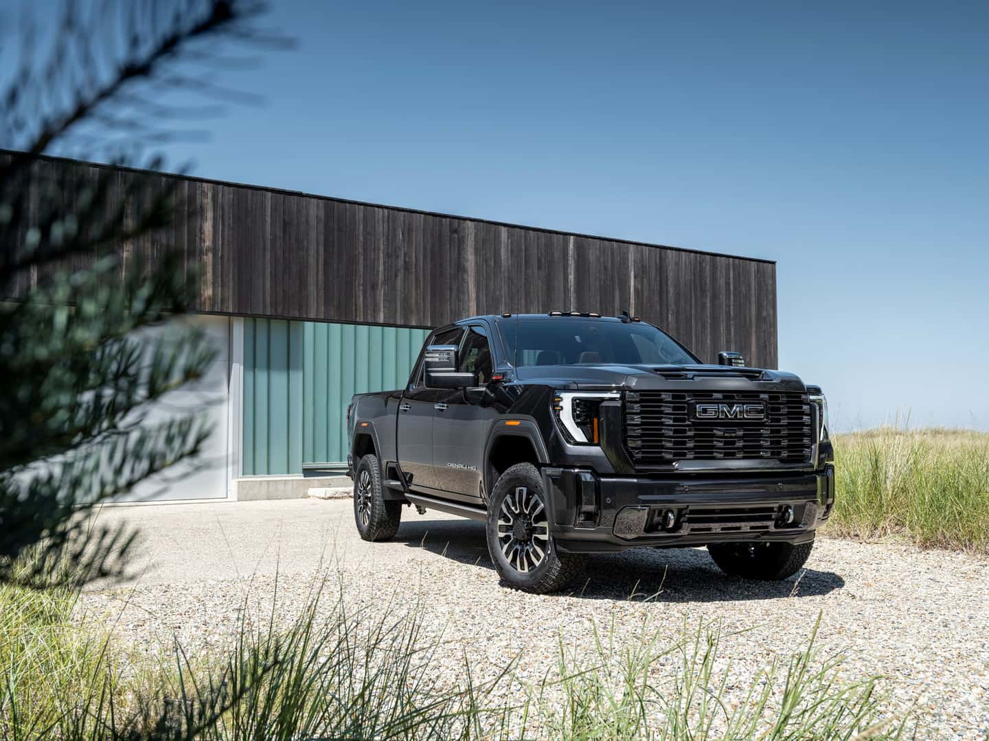 The Safe And Secure 2024 GMC Sierra 2500HD Denali Ultimate Peacefully Parked Outside A Family's Home