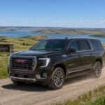 2026 GMC Yukon XL driving on a gravel road through South Dakota prairie near Watertown SD