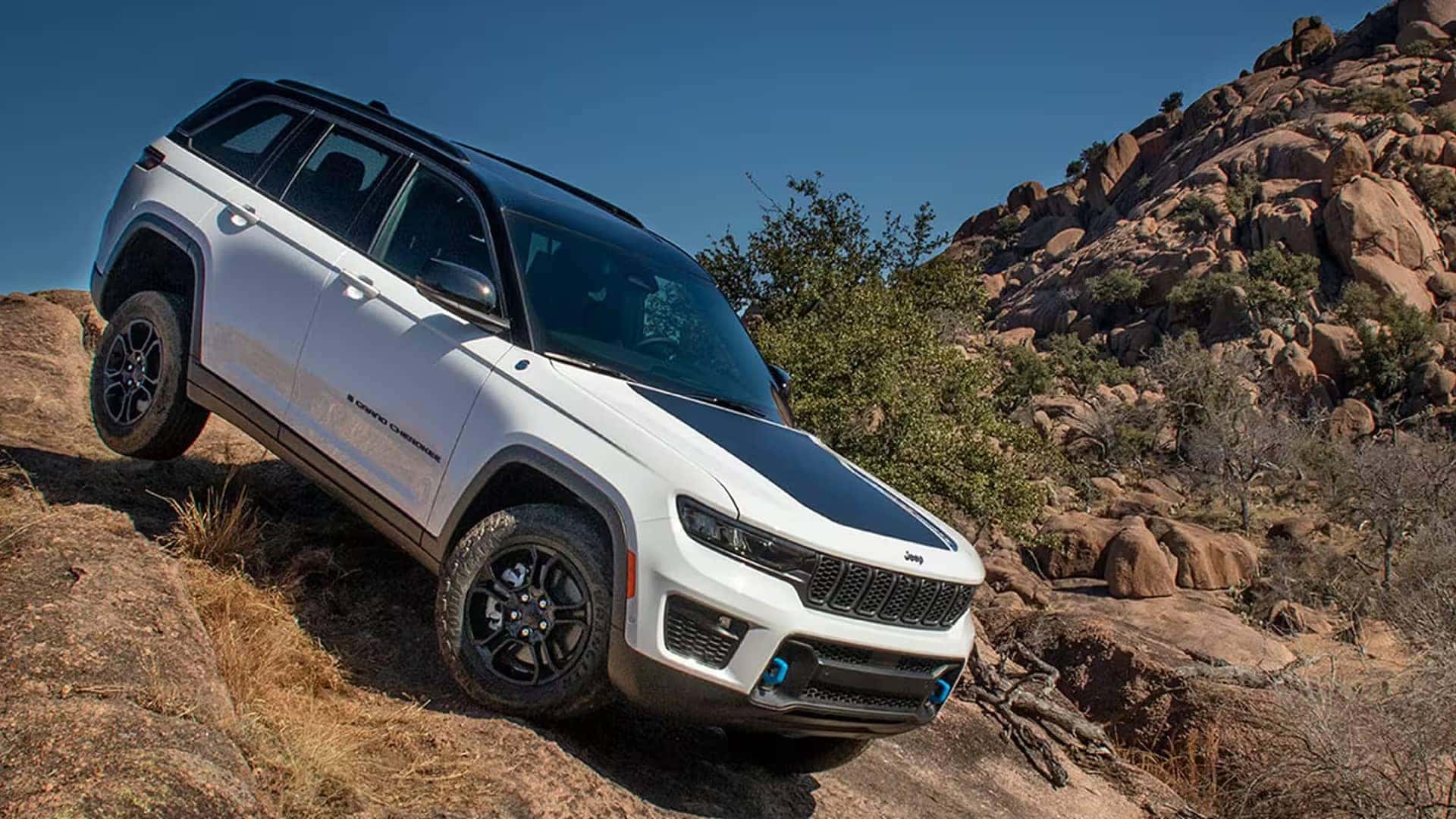 white jeep grand cherokee driving on mountain