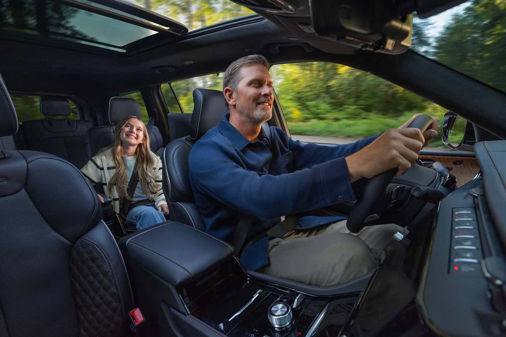 father driving jeep grand cherokee with daughter in back
