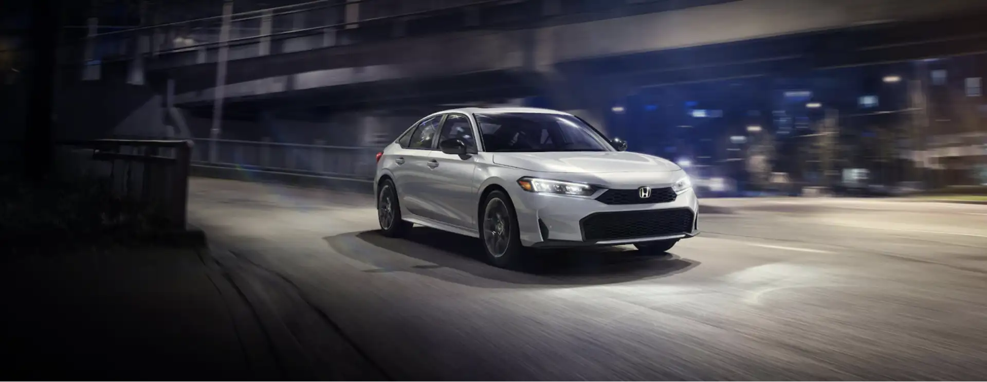 The 2026 Honda Civic Sedan Sport Touring Hybrid shown in Solar Silver Metallic