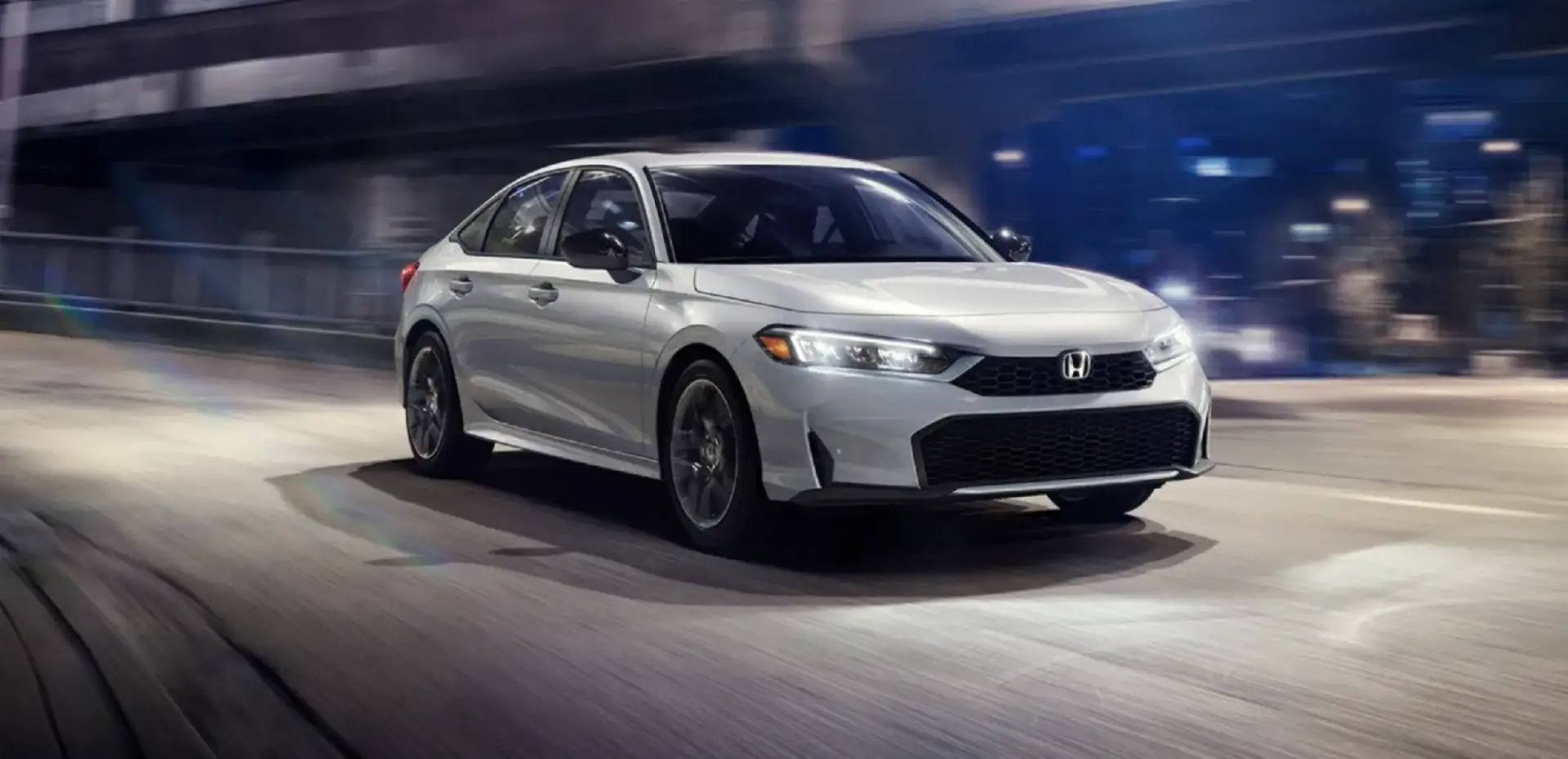 The 2026 Honda Civic Sport Touring Hybrid shown in Solar Silver Metallic