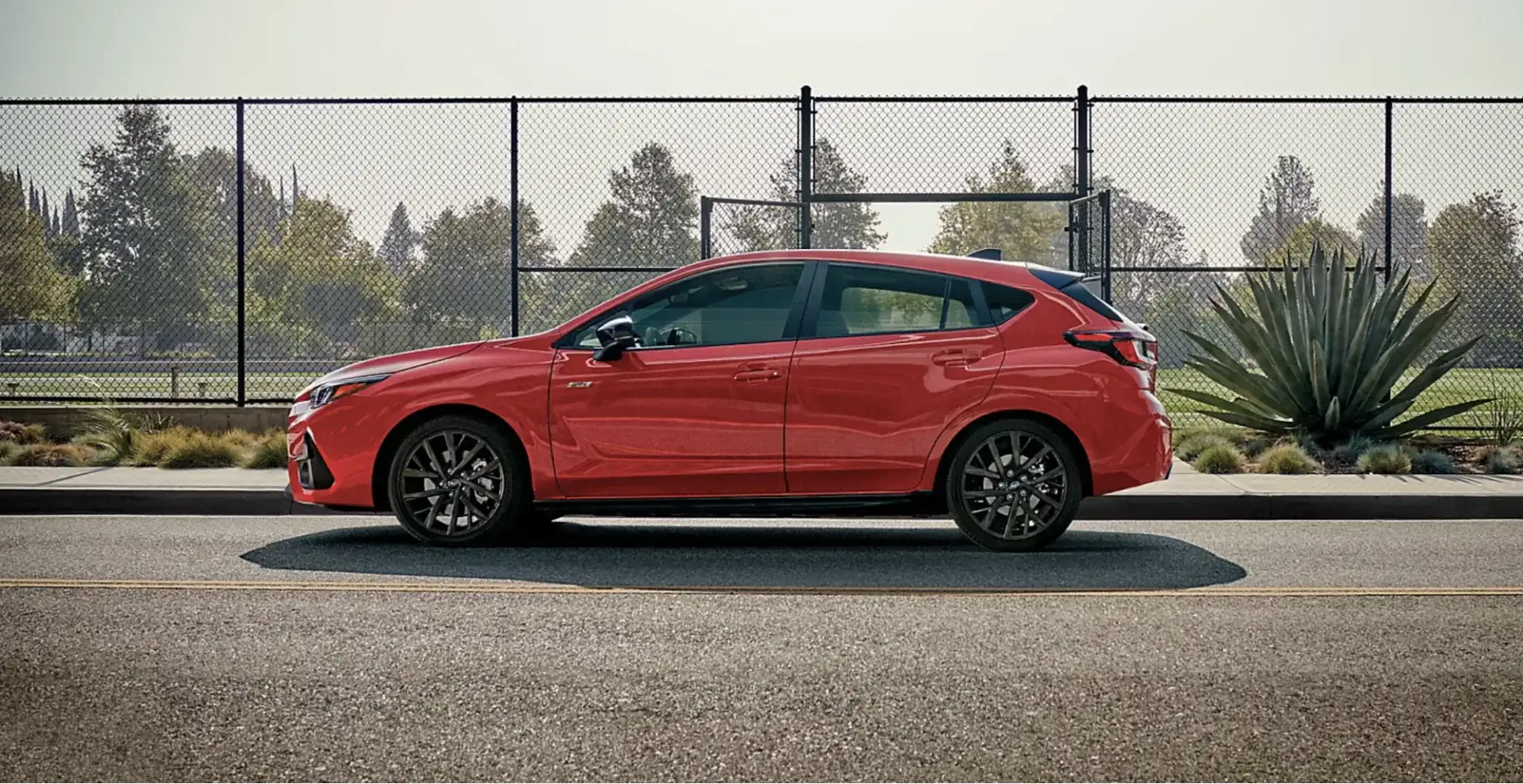 The 2026 Subaru Impreza RS shown in Pure Red