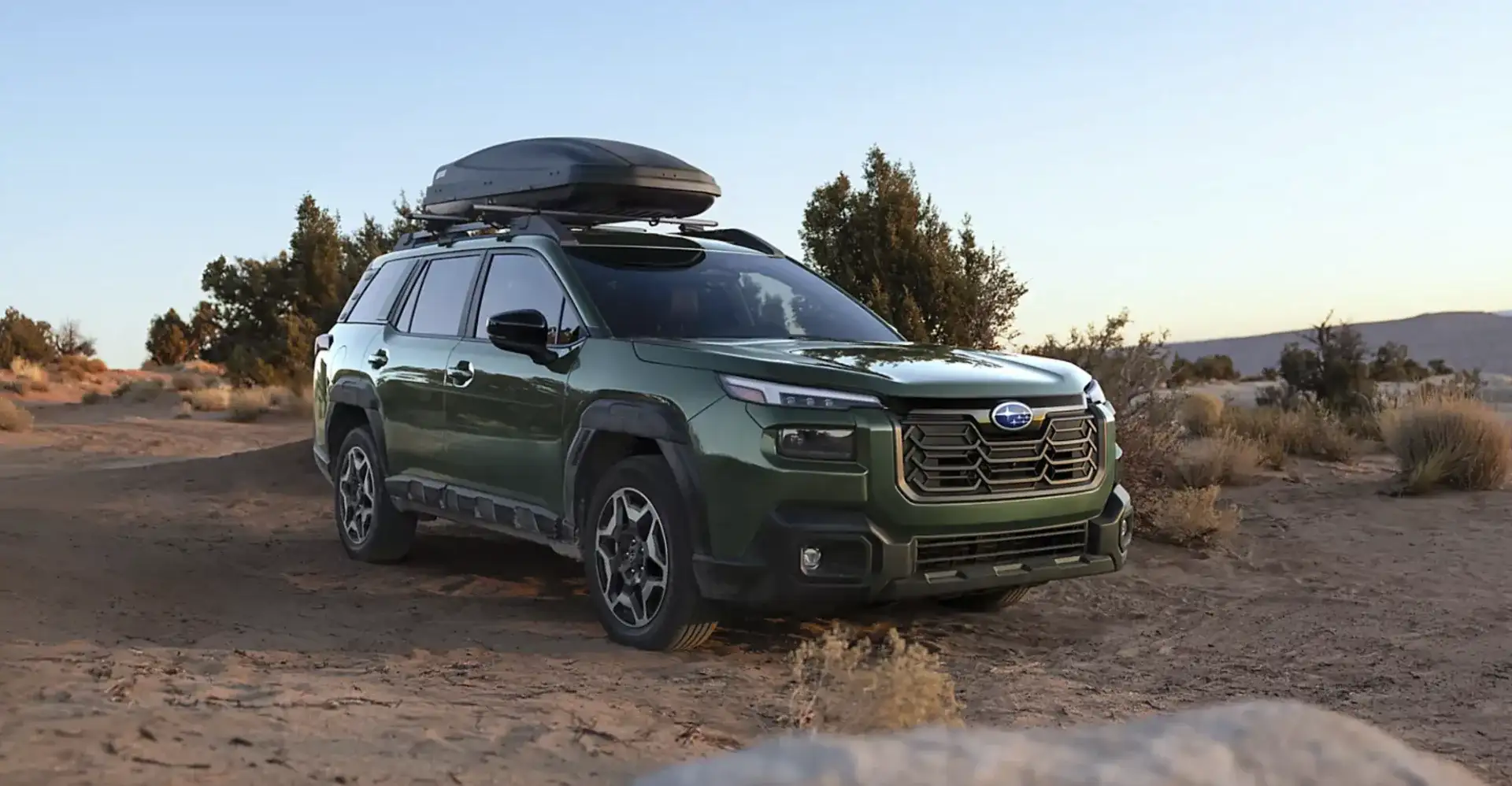 2026 Subaru Outback Touring shown in Deep Emerald Green Pearl with accessory equipment
