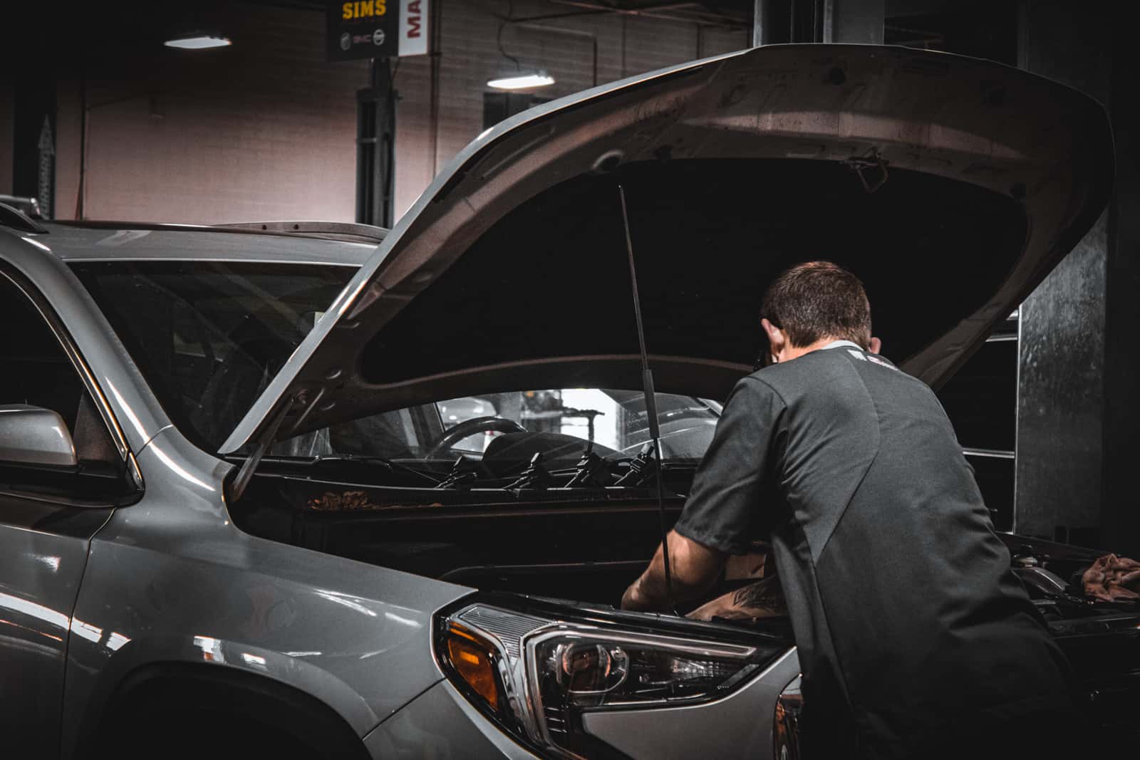 Sims Auto Park technician servicing a GMC vehicle