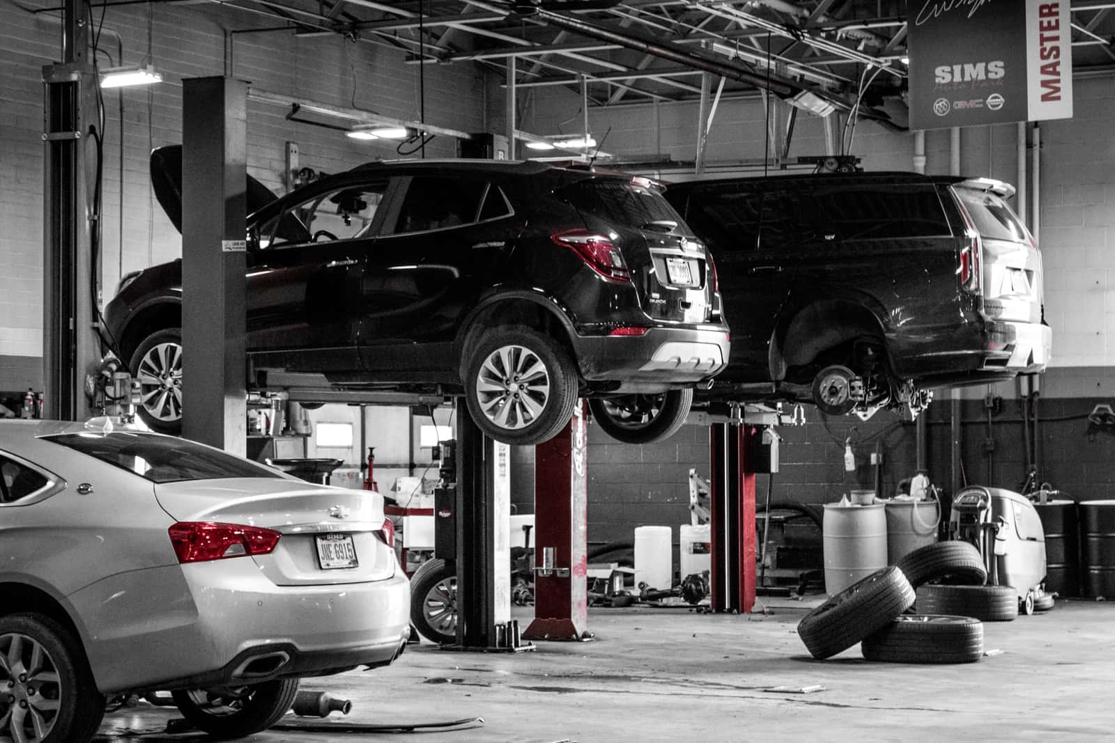Vehicles being serviced inside Sims Auto Park service department