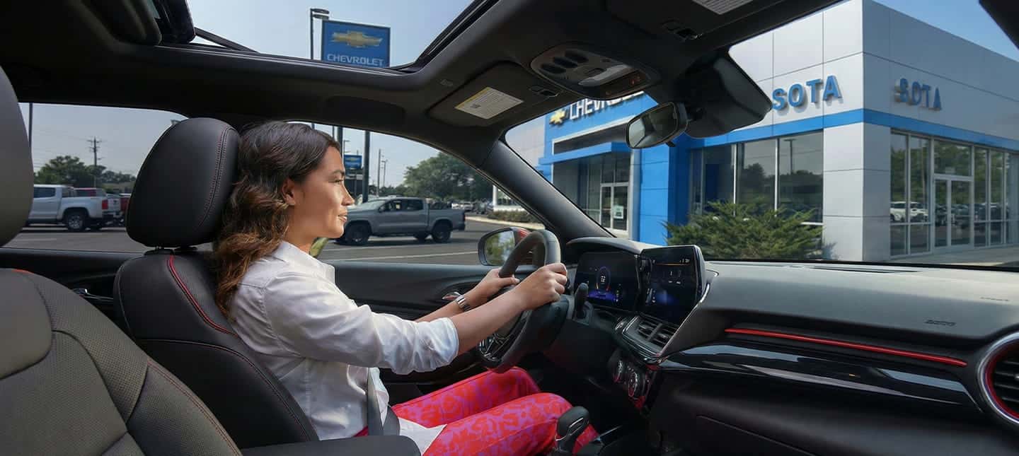 woman driving cal off car lot