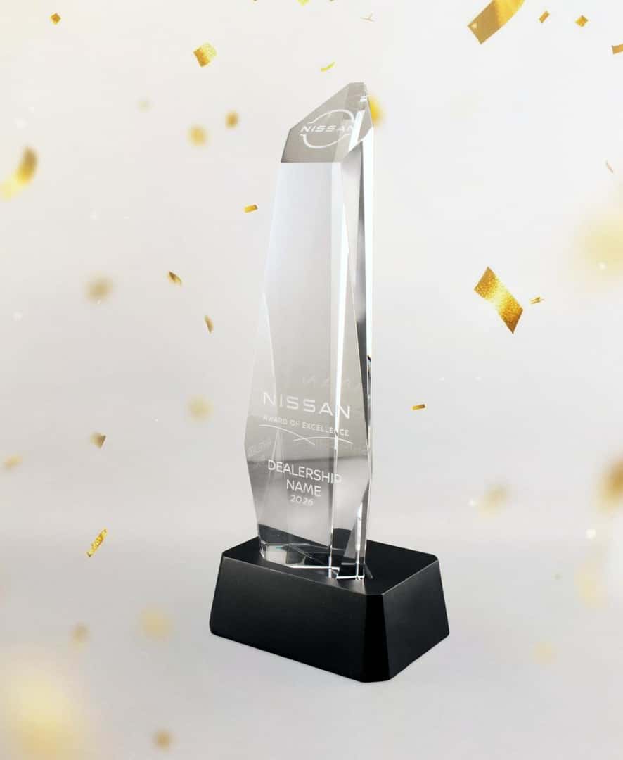 Nissan Award of Excellence trophy displayed with gold confetti in the background.