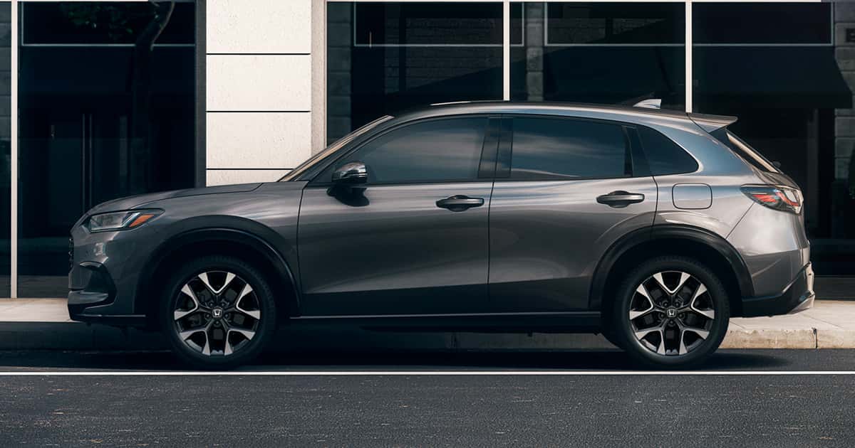 A dark gray Honda HR-V SUV parked on a city street.
