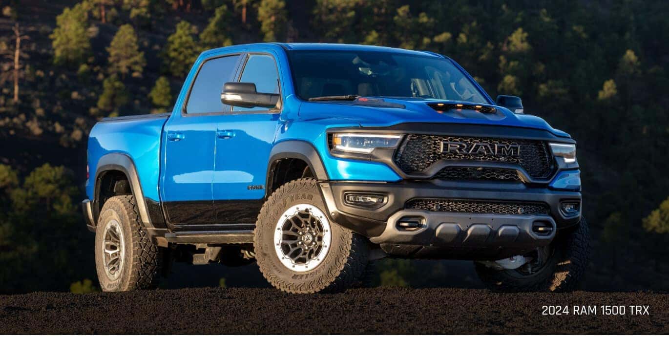 Three-quarter view of a Ram 1500 TRX in Blue parked on a loose volcanic rock ridge.